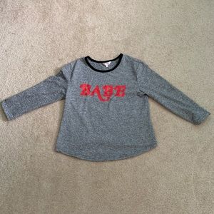 Long sleeved gray top with babe in red on it